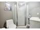Bathroom featuring a glass-enclosed shower, a toilet and a single-sink vanity at 5245 18Th N St, St Petersburg, FL 33714