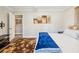 Comfortable bedroom featuring a bed, an area rug, a painting and an adjacent closet at 5245 18Th N St, St Petersburg, FL 33714