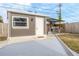 Private backyard with a modern outbuilding and an outdoor kitchen under a metal roof at 5803 Cresthill Dr, Tampa, FL 33615