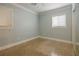 This bedroom has cool blue walls, a window with blinds, and minimalist electrical outlets at 5803 Cresthill Dr, Tampa, FL 33615