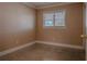 This cozy bedroom features neutral walls, a window with blinds, and classic baseboard trim at 5803 Cresthill Dr, Tampa, FL 33615
