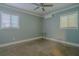 Neutral-toned bedroom with two windows for natural light and ceiling fan at 5803 Cresthill Dr, Tampa, FL 33615