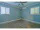 Cozy bedroom featuring a window and ceiling fan at 5803 Cresthill Dr, Tampa, FL 33615