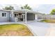 An exterior view of the back of the home showing the covered patio and spacious backyard at 5803 Cresthill Dr, Tampa, FL 33615