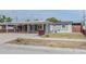 Single-story home featuring a carport, and a well-kept lawn at 5803 Cresthill Dr, Tampa, FL 33615