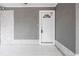 Exterior with gray walls and a white front door with glass and decorative molding at 5803 Cresthill Dr, Tampa, FL 33615