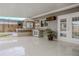 This patio features an outdoor kitchen area, tiled flooring, and french doors to the interior at 5803 Cresthill Dr, Tampa, FL 33615