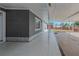 A view of the extended covered patio of the home showing tiled flooring and open space at 5803 Cresthill Dr, Tampa, FL 33615