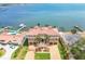 Aerial view of a grand waterfront estate with lush landscaping and a terracotta tile roof at 5810 Mariner St, Tampa, FL 33609