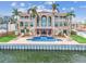 Luxury waterfront home featuring a pool with a waterfall and pergola at 5810 Mariner St, Tampa, FL 33609
