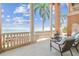 Beautiful covered balcony with water views, columns, balusters, and comfortable outdoor furniture at 5810 Mariner St, Tampa, FL 33609