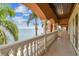 A long, covered balcony featuring decorative pillars and railing offers stunning water views at 5810 Mariner St, Tampa, FL 33609