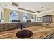 Entertainers bar with granite counters and sink; backdrop of waterfront views at 5810 Mariner St, Tampa, FL 33609