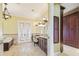 Well-lit bathroom featuring double doors, vanity, and marble tile floors at 5810 Mariner St, Tampa, FL 33609