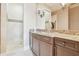 A bathroom features a large shower with decorative tiling and a granite countertop with a single sink at 5810 Mariner St, Tampa, FL 33609
