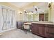 Bathroom featuring double sink vanity, decorative lighting, and luxurious finishes at 5810 Mariner St, Tampa, FL 33609