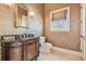 Lavish powder room with decorative wallpaper, marble vanity, and window with natural light at 5810 Mariner St, Tampa, FL 33609