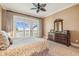 Bedroom with dresser, ceiling fan, and large sliding glass doors opening to a balcony with ocean views at 5810 Mariner St, Tampa, FL 33609