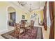 A dining room with an arched entryway, chandelier lighting, and an area rug at 5810 Mariner St, Tampa, FL 33609