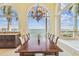 Open-concept dining room with large windows offering stunning ocean views and chandelier at 5810 Mariner St, Tampa, FL 33609