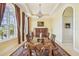Formal dining room with a long wooden table, chandelier, and large windows providing plenty of natural light at 5810 Mariner St, Tampa, FL 33609