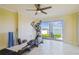 Bright exercise room with water view and a ceiling fan with a full size elliptical exercise machine in view at 5810 Mariner St, Tampa, FL 33609