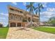 Stunning three-story home featuring a brick driveway, palm trees, and elegant architectural details at 5810 Mariner St, Tampa, FL 33609