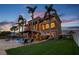 Stunning multi-story home featuring palm trees, well-manicured lawn, and backyard pool at 5810 Mariner St, Tampa, FL 33609