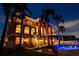 Stunning home featuring a pool, palm trees, manicured landscaping, and waterfront access at 5810 Mariner St, Tampa, FL 33609
