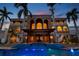 Spectacular home featuring manicured grounds, a covered outdoor living area, and gorgeous blue pool at 5810 Mariner St, Tampa, FL 33609