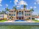 Spectacular waterfront home with a pool and staircase access to balconies and multiple windows at 5810 Mariner St, Tampa, FL 33609