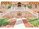 Beautiful home entrance showcasing a stone fountain, manicured landscaping, and a grand staircase at 5810 Mariner St, Tampa, FL 33609