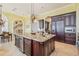 Kitchen featuring a large granite island with seating, modern appliances, and a wine refrigerator at 5810 Mariner St, Tampa, FL 33609