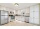 Bright kitchen featuring stainless steel appliances, white cabinetry, and granite countertops at 5810 Mariner St, Tampa, FL 33609