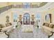 Formal living room with high ceilings, luxurious sofas, and a large ottoman at 5810 Mariner St, Tampa, FL 33609