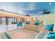 Bright living room with water view, tile floors, and a blue cloud design painted on the ceiling at 5810 Mariner St, Tampa, FL 33609