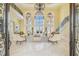 Spacious living room with high ceilings, a chandelier, and large arched windows offering water views at 5810 Mariner St, Tampa, FL 33609