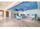 Spacious living room with light tile flooring, seating, and a dining area under a sky-painted ceiling at 5810 Mariner St, Tampa, FL 33609