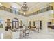 Stately living room with high ceilings, marble floors, luxury finishes, and a view to kitchen at 5810 Mariner St, Tampa, FL 33609