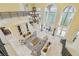 Grand living room with soaring ceilings, elegant chandelier, and abundant natural light at 5810 Mariner St, Tampa, FL 33609
