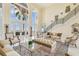 Elegant living room featuring large windows, water views, and classic furnishings for sophisticated living at 5810 Mariner St, Tampa, FL 33609