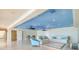 Spacious living room with light tile flooring, seating, and a dining area under a sky-painted ceiling at 5810 Mariner St, Tampa, FL 33609
