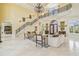 Spacious living room featuring a grand staircase, high ceilings, marble floors, and luxury finishes at 5810 Mariner St, Tampa, FL 33609