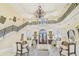 Impressive living room with a grand staircase, ornate chandelier, and elegant furnishings at 5810 Mariner St, Tampa, FL 33609