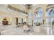 Grand living room featuring a balcony, arched windows, and luxurious seating arrangement overlooking the water at 5810 Mariner St, Tampa, FL 33609