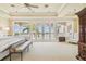 Bright main bedroom with large windows offering stunning water views and access to private balcony at 5810 Mariner St, Tampa, FL 33609