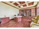 Spacious home office with custom built-in shelving, hardwood floors, and elegant finishes at 5810 Mariner St, Tampa, FL 33609