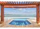 Covered pergola offers shade over an inset spa with an ocean view at 5810 Mariner St, Tampa, FL 33609
