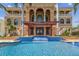 Beautiful home featuring a pool with tiled waterfall, pergola, palm trees, and elegant windows at 5810 Mariner St, Tampa, FL 33609