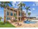 Back of home featuring a pergola, blue tiled waterfall, and a swimming pool with chairs at 5810 Mariner St, Tampa, FL 33609